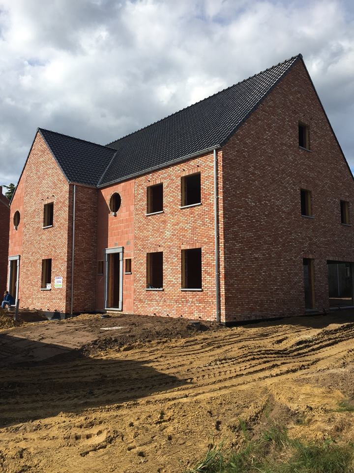 Tall slender porcelain bottle with natural clay textured body and cork stopper.