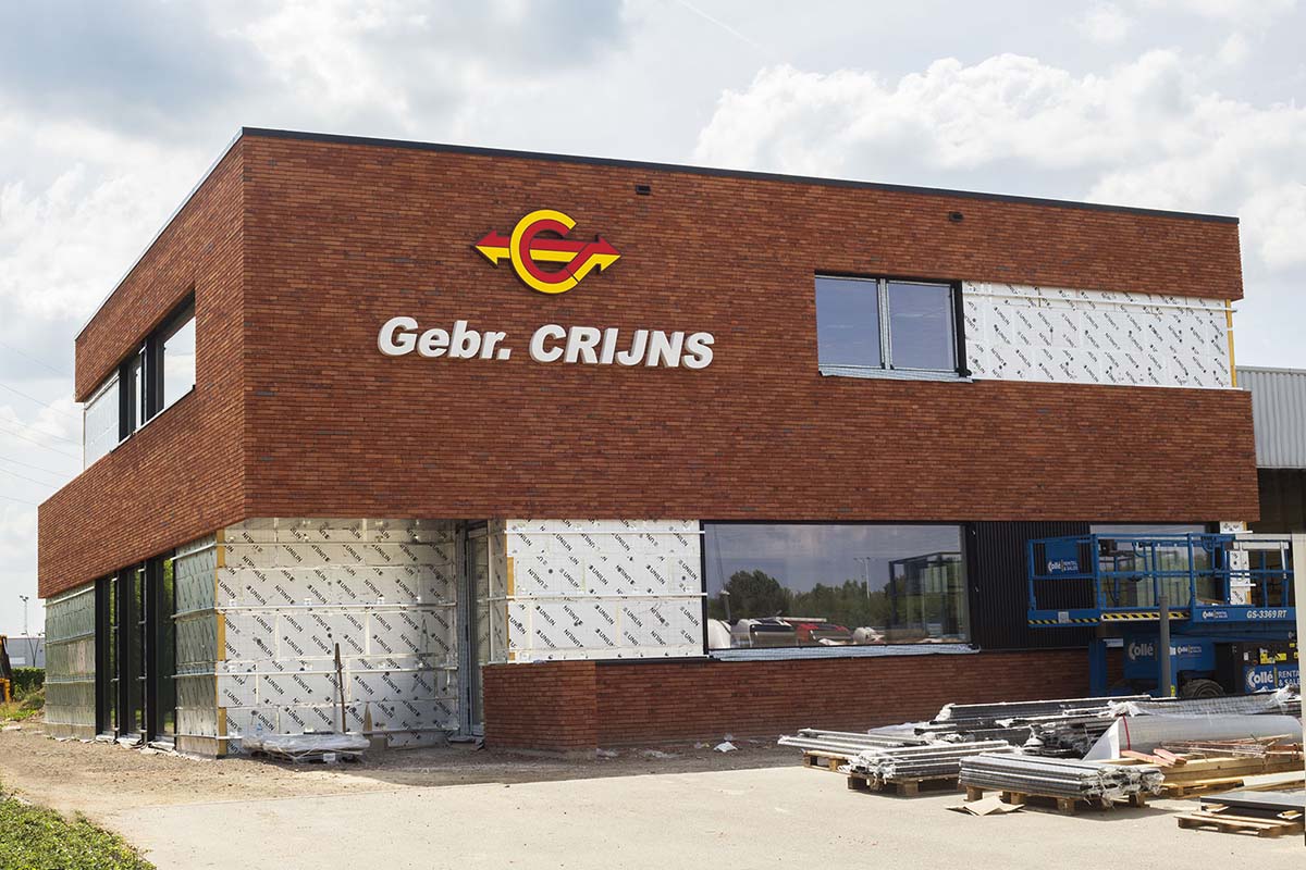 Tall slender porcelain bottle with natural clay textured body and cork stopper.