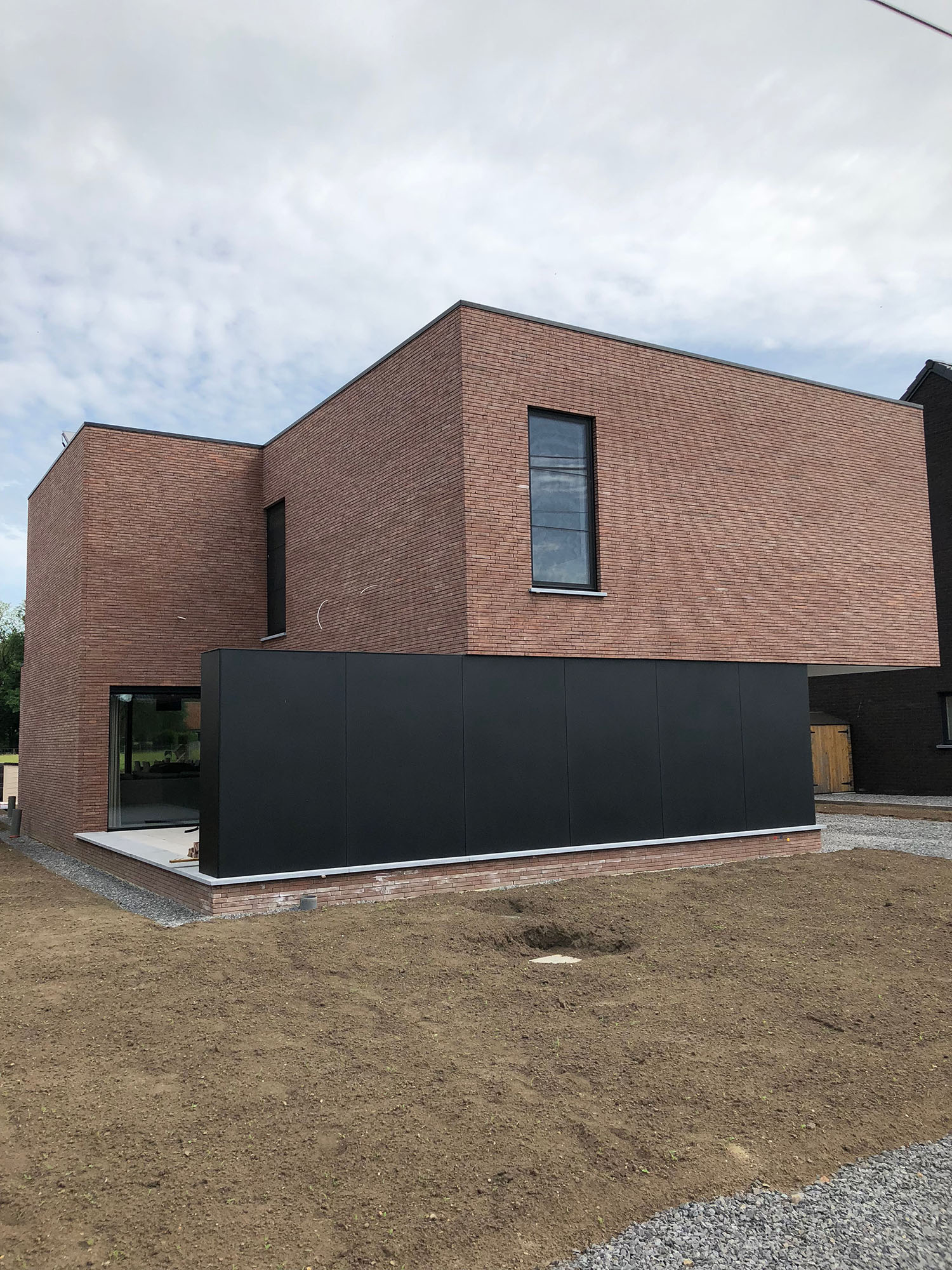 Tall slender porcelain bottle with natural clay textured body and cork stopper.