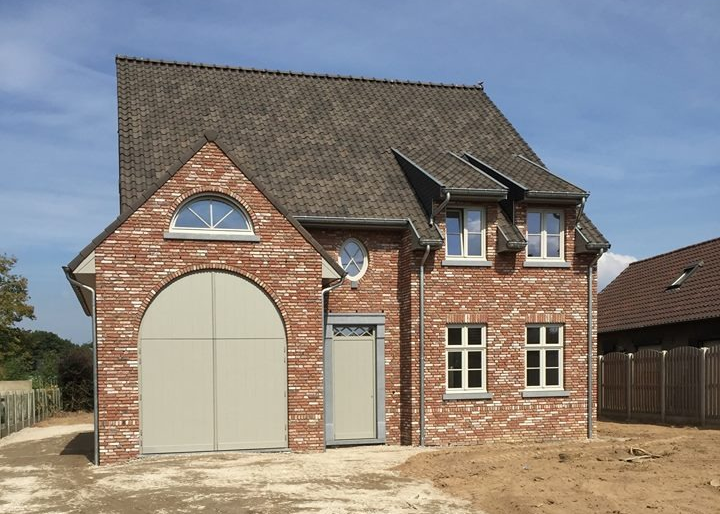 Tall slender porcelain bottle with natural clay textured body and cork stopper.