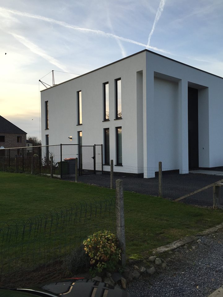 Tall slender porcelain bottle with natural clay textured body and cork stopper.