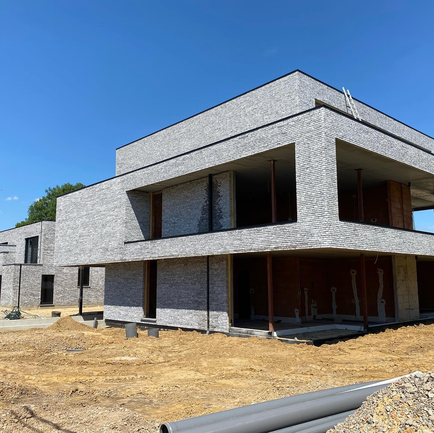 Tall slender porcelain bottle with natural clay textured body and cork stopper.